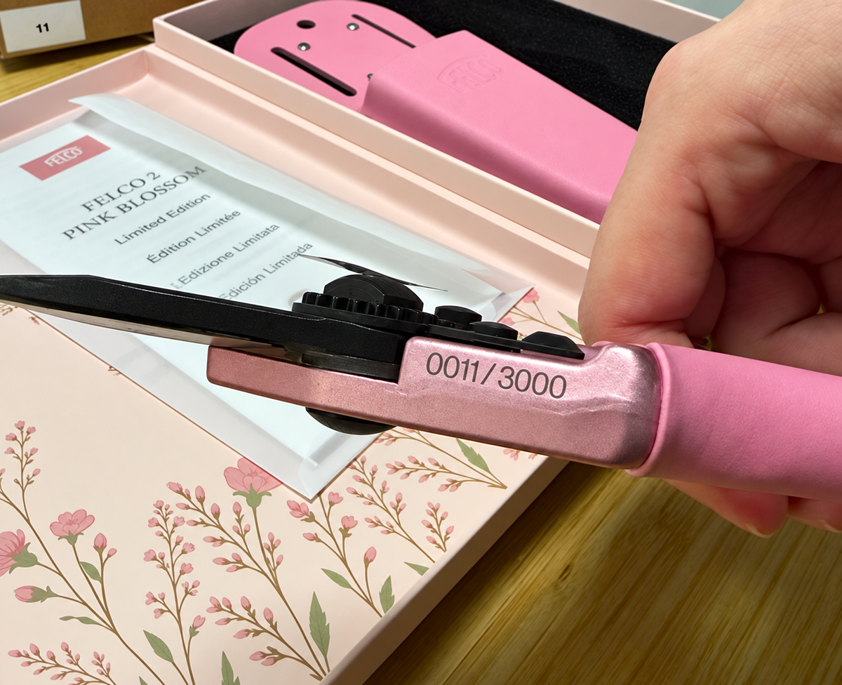 FELCO Pink Blossom pruning shear numbered 0011 of 3000 held over its pink holster, presentation box, and leaflet.